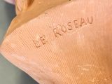 a hand that is holding a vase with writing on it
