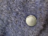 a close up of a stuffed animal with a button on it