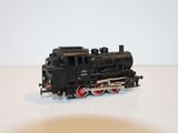 a toy train sitting on a table with a white background