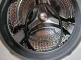 a close up of a washing machine with the door open