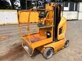 a yellow scissor that is parked in the dirt