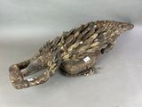 a sculpture of a bird that is sitting on a table