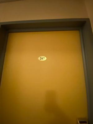 a yellow door with a sign on it in a room