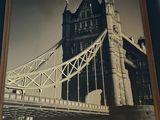 a picture of a picture of a bridge hanging on the wall