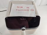 a toilet paper dispenser with a note attached to it