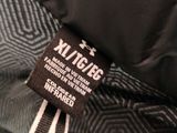 the label on a black jacket with a black and white pattern