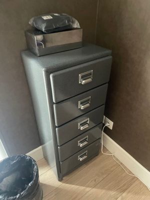 an image of a filing cabinet with a printer on top of it