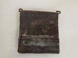 a small metal purse hanging on the wall