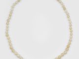 a single strand of white opalite beads with a gold clasp
