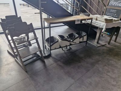a desk and chairs in a room with a staircase