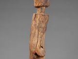 a wooden sculpture of a man with a hat on his head