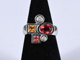 a close up of a ring on a black stand with a white background