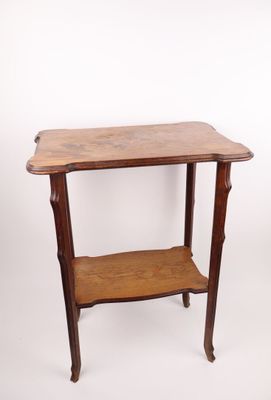 an old wooden table with a shelf on top of it
