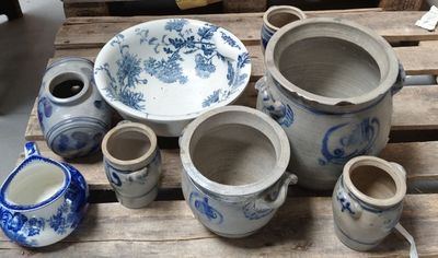 many blue and white vases sitting on a wooden table