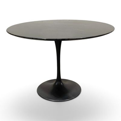 a black table with a round top and a black base