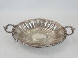 an antique silver plate with handles and handles on a white background