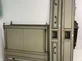a bed that has a bunch of luggage on top of it