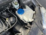 the engine of a car with its hood open on the street