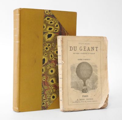 an old book with a yellow cover sitting next to a yellow book