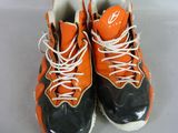 pair of orange and black sneakers with white laces on them