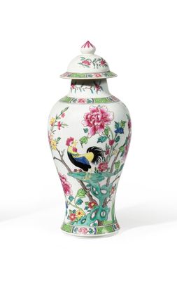 a white vase with a bird and flowers on it