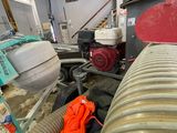 a large pipe in the middle of a room with a red jacket on it