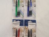 four different colored pens sitting on top of each other on a white surface