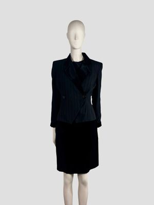 a mannequin wearing a black dress and a black jacket