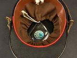 a hat with a cell phone in it on a table