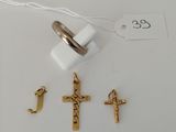 a close up of a ring with a cross on it next to other items