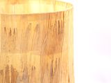a close up of a wooden vase on a white surface