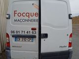 a white van that is parked in front of a building
