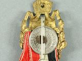 an image of a medal with a red, white, and blue ribbon