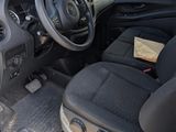 the interior of a small car with a steering wheel and dashboard