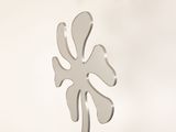a metal sculpture of a flower on a table