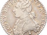 a close up of a silver coin with a man ' s head on it