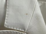 a close up of a white shirt on a hanger