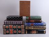 several books are stacked on top of each other on a white surface