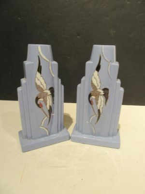 two blue bookends with a bird design on them