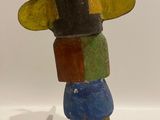 an image of a wooden sculpture of a person holding a surfboard