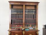 a large bookcase with many books on it in a living room