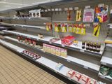 many shelves in the store that have different types of food on them