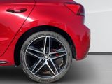 the rear end of a red car parked in a garage