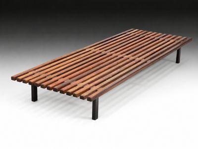 a wooden bench sitting on top of a white floor