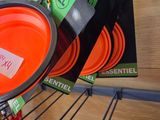 several orange plates are stacked on a rack in a store