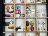 a shadow box filled with many different types of brooches
