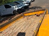 many cars that are parked on the side of the road