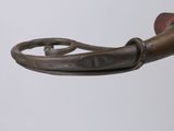 a close up of a metal object on a white surface