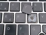 a small piece of plastic sitting on top of a computer keyboard