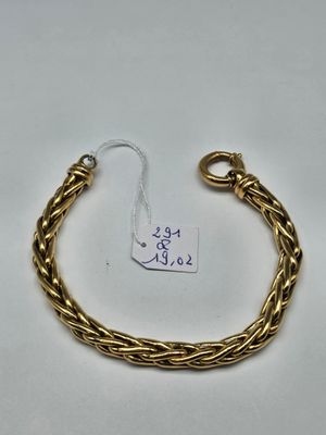 a close up of a gold bracelet with a tag on it